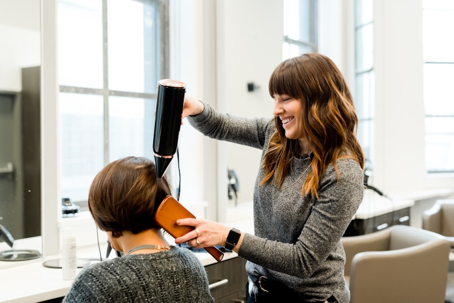 A stylist blow-drying a client's hair in a bright salon
